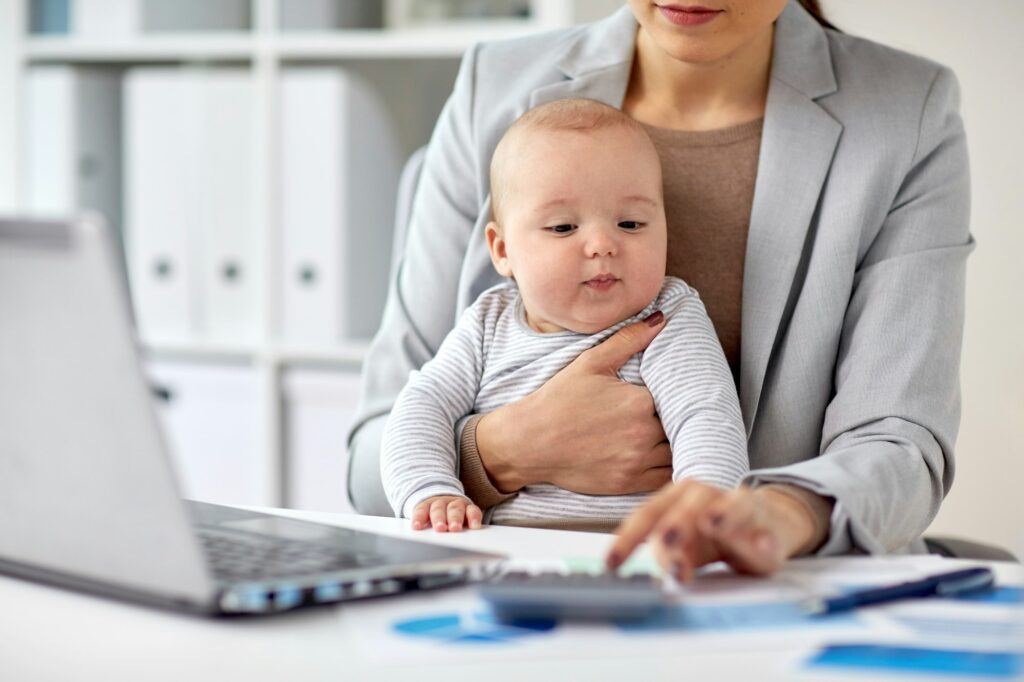 businesswoman with baby working at office