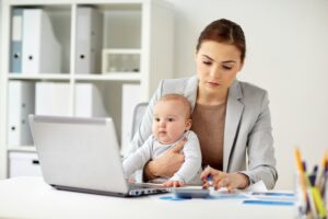 businesswoman with baby working at office