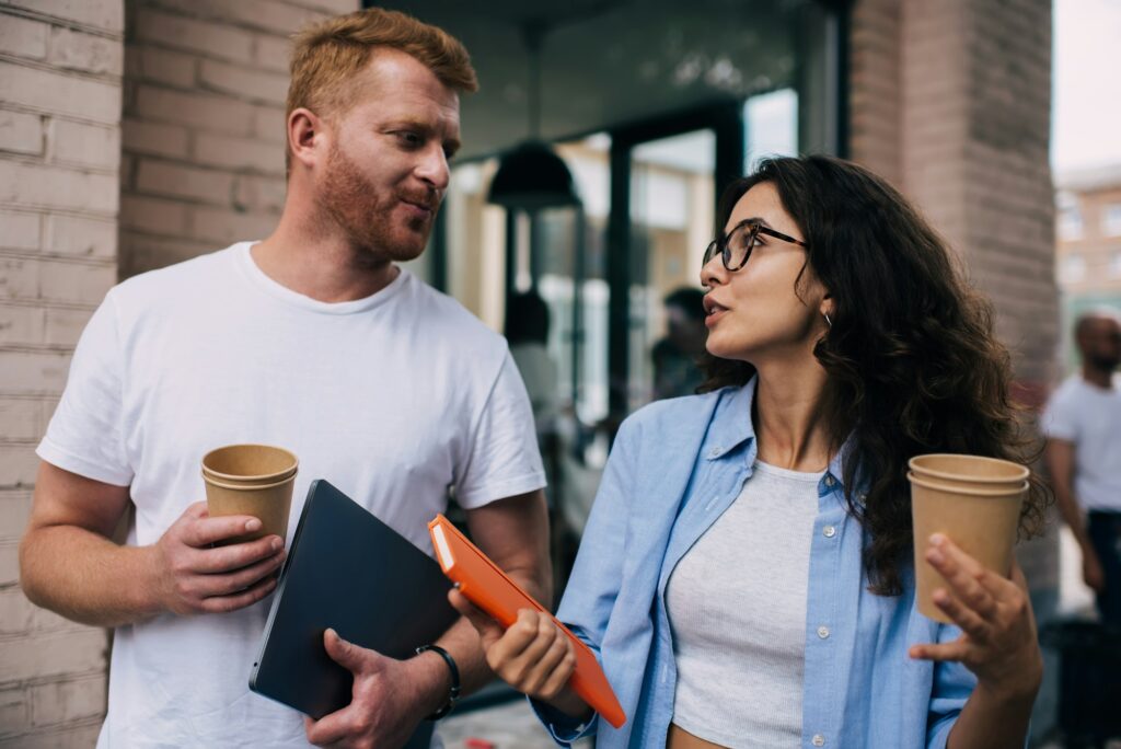 Positive colleagues going back to work after break in cafe